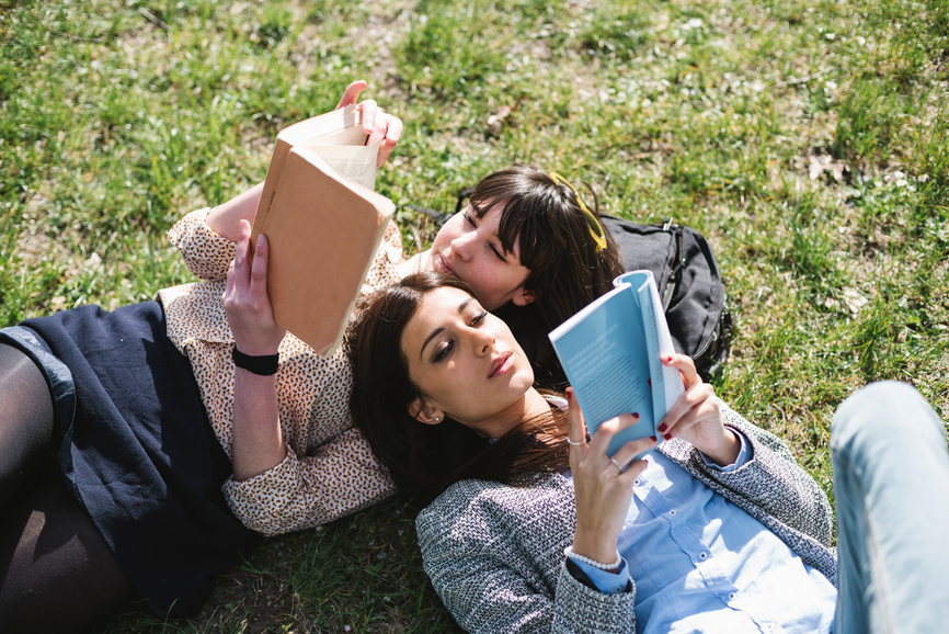 Two girls reading books